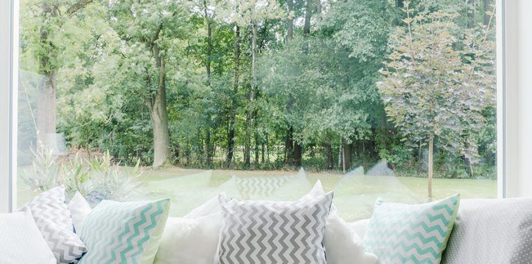 Large picture window looking out over a green yard